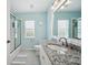 Bright bathroom featuring a granite countertop vanity, a shower with a glass door, and a large mirror at 2336 Edelweiss Loop, Trinity, FL 34655