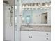 Close up of a shower and dual sinks with granite countertops, with ample lighting at 2336 Edelweiss Loop, Trinity, FL 34655