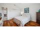 Well-lit bedroom featuring hardwood floors, a double closet, and a window with a view at 2336 Edelweiss Loop, Trinity, FL 34655
