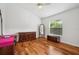 Bright bedroom with hardwood floors, a large mirror, and a window overlooking the outdoors at 2336 Edelweiss Loop, Trinity, FL 34655