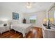 Cozy bedroom with hardwood floors, a window with a view, and tasteful furnishings at 2336 Edelweiss Loop, Trinity, FL 34655