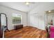 Bedroom featuring hardwood floors, a large mirror, closet doors, and a window with a view at 2336 Edelweiss Loop, Trinity, FL 34655