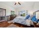 Bright bedroom featuring hardwood floors, a ceiling fan, and a window with a view at 2336 Edelweiss Loop, Trinity, FL 34655