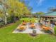 Community picnic area with tables, shelter, and play area nestled among mature trees in a well-maintained setting at 2336 Edelweiss Loop, Trinity, FL 34655