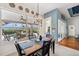 Bright dining area offers pool views, a modern chandelier, and sliding door access at 2336 Edelweiss Loop, Trinity, FL 34655