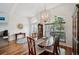 Open dining room with chandelier, hardwood floors, and bright natural light at 2336 Edelweiss Loop, Trinity, FL 34655