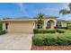 Inviting home with manicured landscaping, attached garage, and a blue sky overhead at 2336 Edelweiss Loop, Trinity, FL 34655