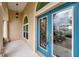 Close-up of a decorative blue front door with glass detailing and sidelight window at 2336 Edelweiss Loop, Trinity, FL 34655