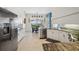 Open concept kitchen featuring granite counters, white cabinetry and stainless steel appliances with view of the patio at 2336 Edelweiss Loop, Trinity, FL 34655