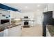 Modern kitchen boasts granite countertops, white cabinetry, stainless appliances, and ample natural light at 2336 Edelweiss Loop, Trinity, FL 34655