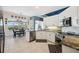 Bright kitchen with granite countertops, white cabinets, stainless steel appliances, and an adjacent dining area at 2336 Edelweiss Loop, Trinity, FL 34655