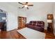 Comfortable living room featuring a plush sofa, hardwood floors, and a bookcase at 2336 Edelweiss Loop, Trinity, FL 34655