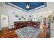 Spacious living room features hardwood floors, blue tray ceiling, and comfortable sectional sofa at 2336 Edelweiss Loop, Trinity, FL 34655