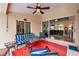 Inviting outdoor seating area with a ceiling fan, comfortable seating, and views into the living room at 2336 Edelweiss Loop, Trinity, FL 34655