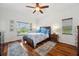 Comfortable main bedroom features hardwood floors, neutral walls, and natural light at 2336 Edelweiss Loop, Trinity, FL 34655