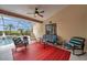 Relaxing covered lanai with a ceiling fan, stylish seating, and views of the screened pool at 2336 Edelweiss Loop, Trinity, FL 34655