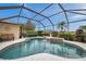 Sparkling screened-in pool with waterfall feature and ample space for relaxation at 2336 Edelweiss Loop, Trinity, FL 34655