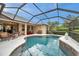 Inviting screened pool featuring a spillover spa and outdoor dining and lounge area at 2336 Edelweiss Loop, Trinity, FL 34655