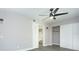 This vacant bedroom offers an ensuite bathroom, new floors, and a ceiling fan with a light at 2464 Australia E Way # 46, Clearwater, FL 33763