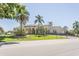 A street view shows the exterior of a single-story commercial building with mature landscaping and a portico at 2464 Australia E Way # 46, Clearwater, FL 33763