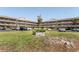 An exterior shot of a multi-story residential building with manicured grounds and assigned parking at 2464 Australia E Way # 46, Clearwater, FL 33763