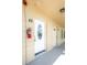 Close-up of condo unit entrances with unit number, white doors, and exterior details in a hallway at 2464 Australia E Way # 46, Clearwater, FL 33763