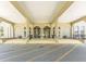 Inviting building entrance features covered walkway, glass doors, with symmetrical landscaping and access at 2464 Australia E Way # 46, Clearwater, FL 33763