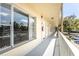 Exterior condo hallway with view of balcony, windows, and unit entrances, creating a sense of community at 2464 Australia E Way # 46, Clearwater, FL 33763