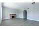 Bright, open living room with wood-look flooring, neutral paint and a decorative fireplace feature at 2464 Australia E Way # 46, Clearwater, FL 33763