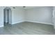 A well-lit living room features stylish laminate flooring, neutral paint, and a modern aesthetic at 2464 Australia E Way # 46, Clearwater, FL 33763