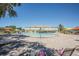 Community pool with lounge chairs and umbrellas, creating a relaxing and inviting outdoor space at 2464 Australia E Way # 46, Clearwater, FL 33763