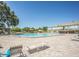 Expansive pool area features comfortable lounge chairs for relaxation on the brick-paved deck, with plenty of umbrellas at 2464 Australia E Way # 46, Clearwater, FL 33763