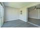 An empty room featuring new gray flooring and sliding glass doors to an outdoor balcony at 2464 Australia E Way # 46, Clearwater, FL 33763