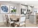 Elegant dining area with a wooden table, upholstered chairs, decorative accents, and seamless flow into the modern kitchen at 285 Voltaire Dr, Spring Hill, FL 34609
