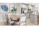Elegant dining area with a wooden table, upholstered chairs, decorative accents, and seamless flow into the modern kitchen at 285 Voltaire Dr, Spring Hill, FL 34609