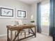 Cozy home office with a rustic wooden desk, comfortable chair, and natural light streaming through the window and blue accents at 285 Voltaire Dr, Spring Hill, FL 34609