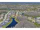 Wonderful aerial view of a home in a beautiful community with ponds and mature trees at 3042 Gianna Way, Land O Lakes, FL 34638