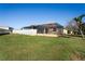 Spacious backyard featuring a well-maintained lawn, white fence, and inviting screened-in pool, ideal for outdoor enjoyment at 3042 Gianna Way, Land O Lakes, FL 34638