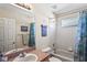 Bathroom with tiled shower, decorative shower curtain and single sink vanity at 3042 Gianna Way, Land O Lakes, FL 34638