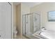 Bright bathroom showcases a glass enclosed shower and a deep soaking tub with jets at 3042 Gianna Way, Land O Lakes, FL 34638