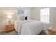 Comfortable bedroom with neutral tones, featuring a nightstand and window at 3042 Gianna Way, Land O Lakes, FL 34638