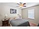 Bedroom featuring a queen-size bed, nightstand, and window at 3042 Gianna Way, Land O Lakes, FL 34638