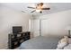 Bedroom with ceiling fan, closet, tv, and neutral decor at 3042 Gianna Way, Land O Lakes, FL 34638
