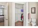 Walk-in closet with shelving and hanging storage, adjacent to a toilet at 3042 Gianna Way, Land O Lakes, FL 34638