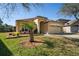 Charming home featuring a well-manicured lawn, inviting facade, and spacious two-car garage, radiating curb appeal at 3042 Gianna Way, Land O Lakes, FL 34638