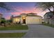 Charming single-Gathering home with well-manicured lawn and driveway with manicured landscaping at 3042 Gianna Way, Land O Lakes, FL 34638