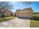 Charming home featuring a well-manicured lawn, inviting facade, and spacious two-car garage, radiating curb appeal at 3042 Gianna Way, Land O Lakes, FL 34638