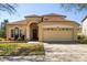 Charming two-story home with a manicured front yard and attached two-car garage at 3042 Gianna Way, Land O Lakes, FL 34638