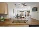 Kitchen featuring laminate countertops open to living room with ceiling fans and outdoor view at 3042 Gianna Way, Land O Lakes, FL 34638