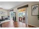 Bright living room showcases sliding doors to a screened patio, wood floors, and a stylish décor at 3042 Gianna Way, Land O Lakes, FL 34638